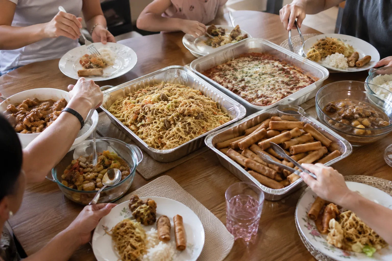 Family members serving themselves from a shared Mother’s Day meal at home